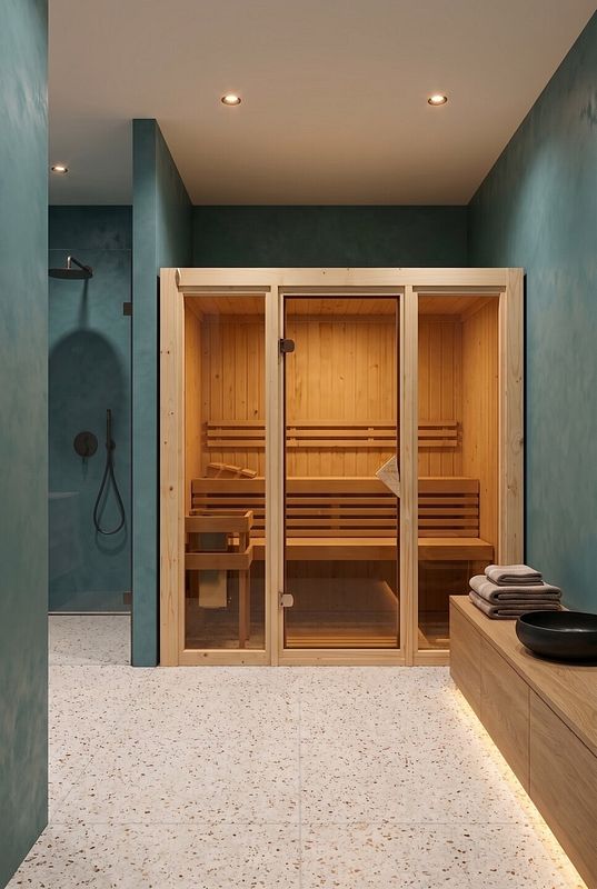 Eine Sauna mit Glasfront in eimem Wellnessbereich mit blaugrünen Wänden
