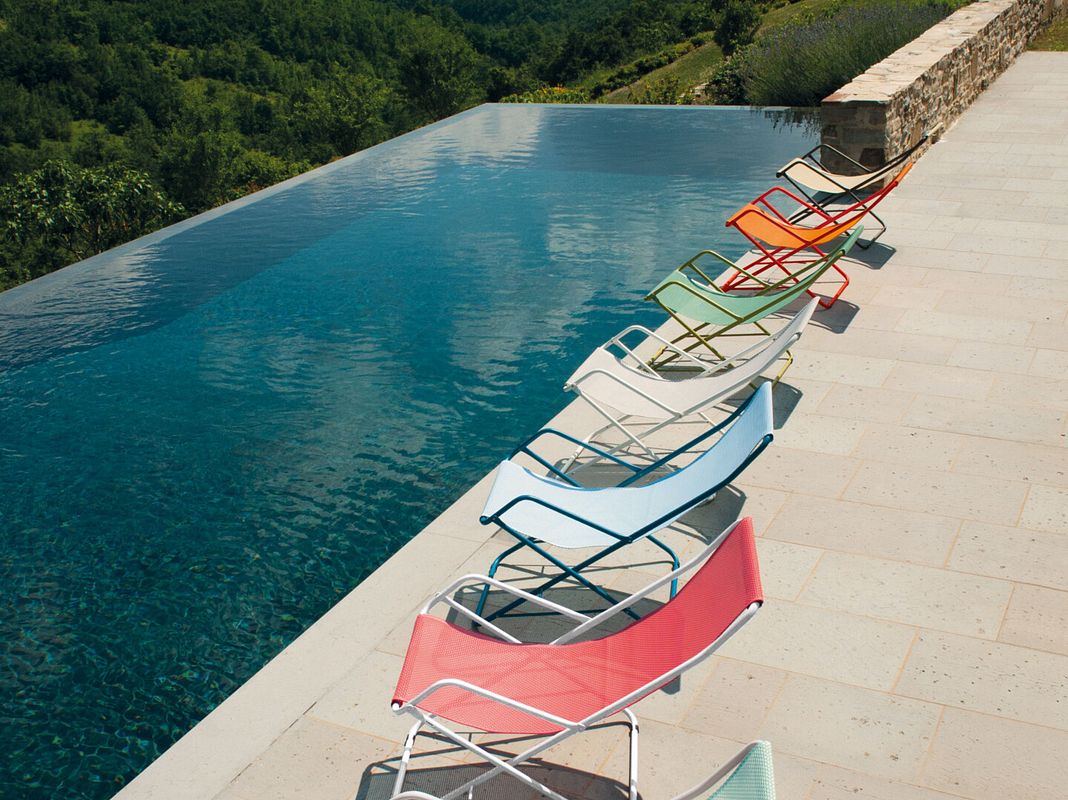Farbenfrohe Liegestühle am Pool