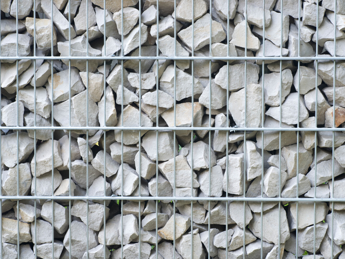 Gabione mit weißen steinen in kleinen Bruchstücken